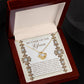 To Mom Of Groom, New Mother - Love Knot Necklace with an interlocking heart pendant, adorned with cubic zirconia crystals, on a card reading: “Mother of the Groom” and a heartfelt message appreciating the groom's mother. Available in white gold or yellow gold finish.