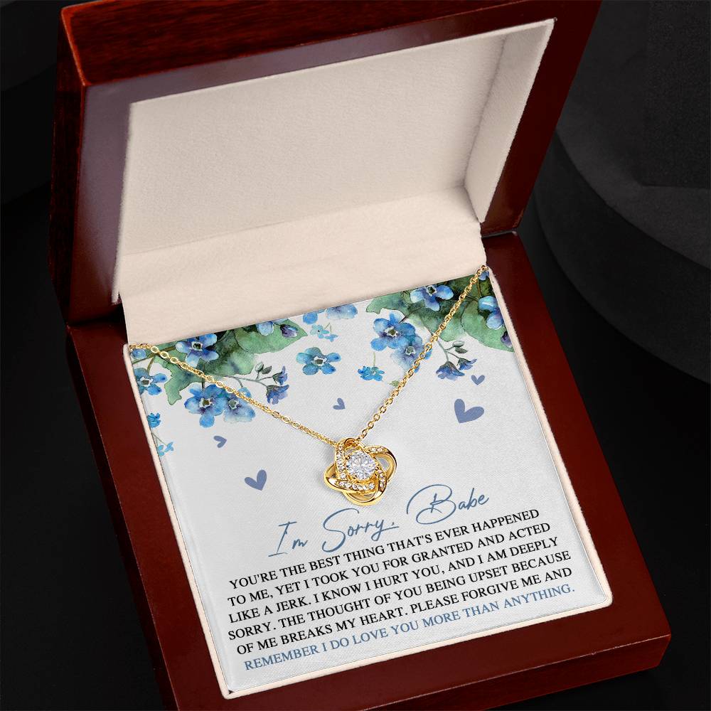 Introducing the "Sorry-More Than Anything - Love Knot Necklace," featuring a cubic zirconia pendant set against a floral background. This heartfelt personalized gift comes with a note that reads, "I'm Sorry, Babe. You're the best thing that's ever happened to me... Please forgive me and remember I do love you more than anything.