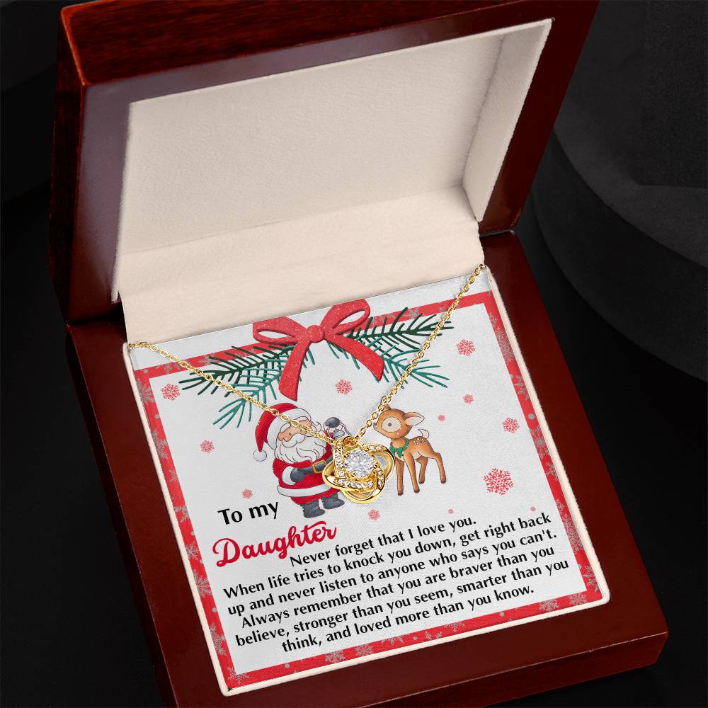 The Daughter-Get Back Up - Love Knot Necklace, embellished with dazzling cubic zirconia, is elegantly presented in a gift box alongside a card depicting Santa and a reindeer. It delivers an inspiring message to a daughter about love and perseverance, making it an ideal personalized gift for the season.