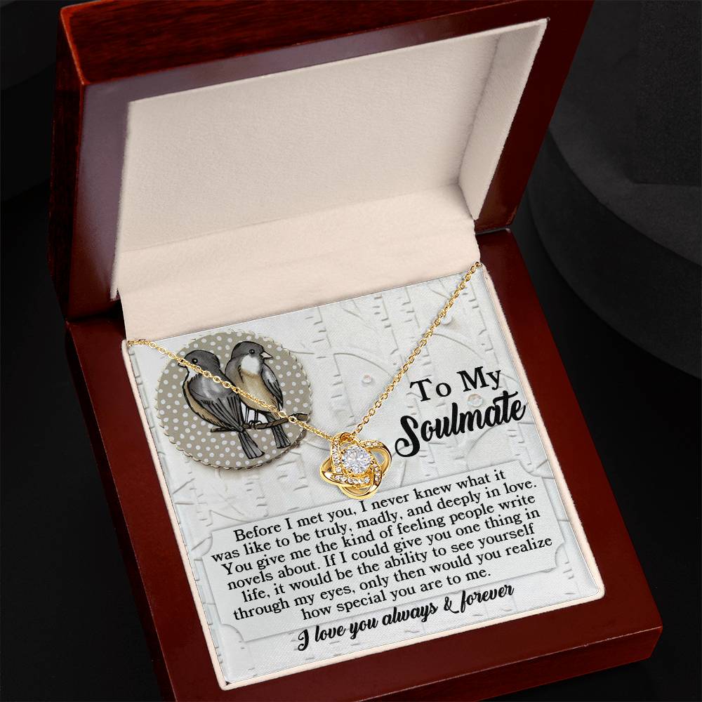 The Soulmate-Write Novels - Love Knot Necklace, crafted in a luxurious white or yellow gold finish, is presented in a gift box complete with a message card showcasing a bird illustration and romantic text. Embellished with cubic zirconia crystals, it represents the perfect symbol of love and elegance.