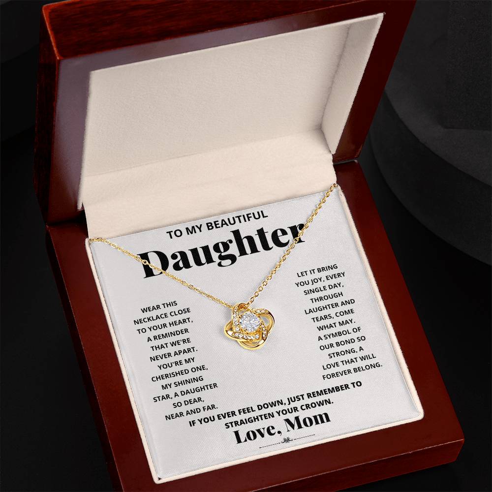 To My Beautiful Daughter, Wear This Necklace - Love Knot Necklace shaped pendant necklace with encrusted jewels on a card with a sentimental message from a mother to her daughter.