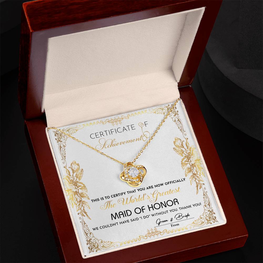 Presenting the "To Maid Of Honor, Certificate Of Achievement - Love Knot Necklace," designed to honor the world's greatest maid of honor. This exquisite necklace, offered in a choice of white gold or yellow gold finish and adorned with shimmering cubic zirconia, represents the heartfelt gratitude of the bride and groom for their invaluable role in the wedding.