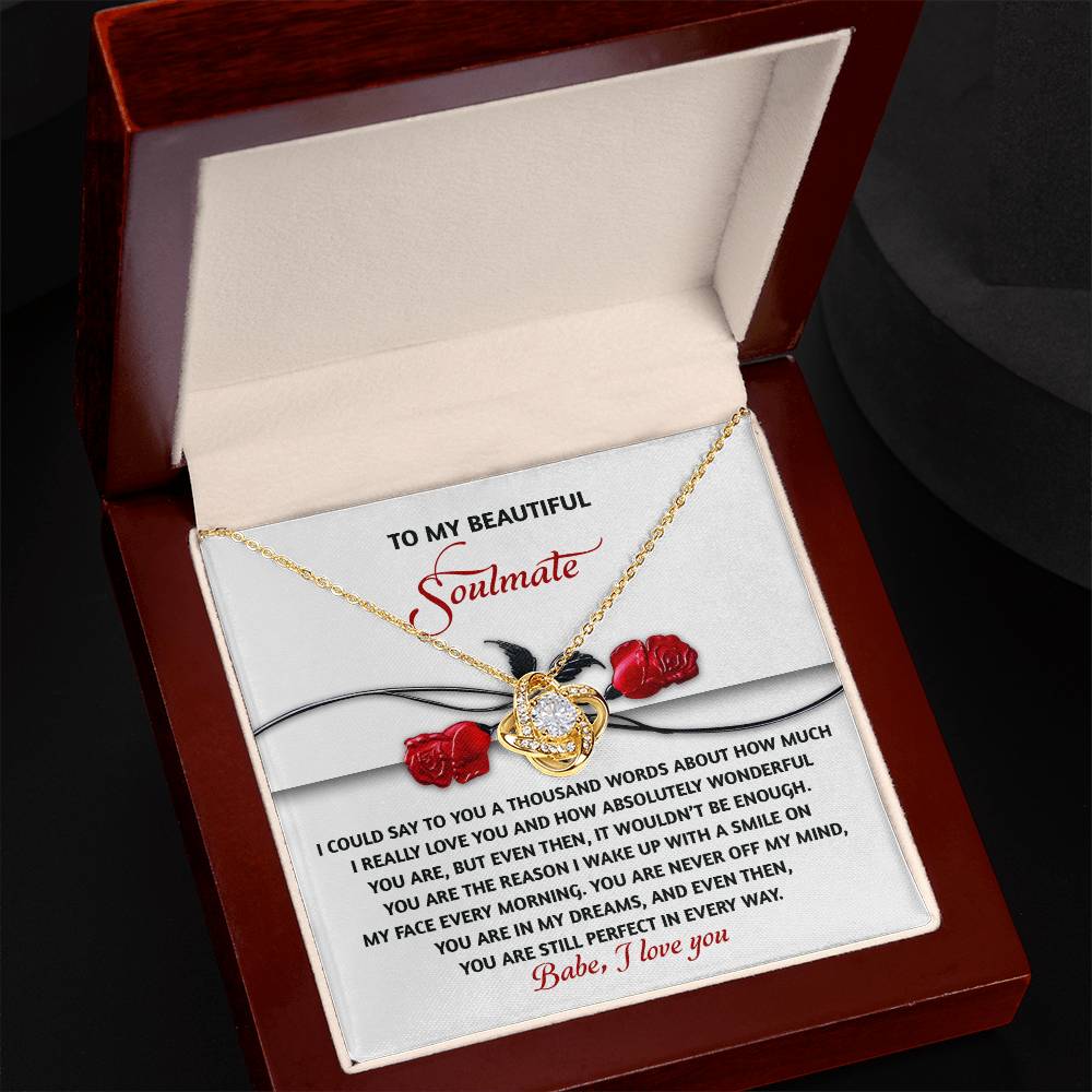 The Soulmate-Every Morning Love Knot Necklace, adorned with cubic zirconia crystals, is presented in an open wooden box. Inside is a romantic card addressed to a "Beautiful Soulmate," featuring roses and heartfelt text, ideal as a personalized gift for any occasion.