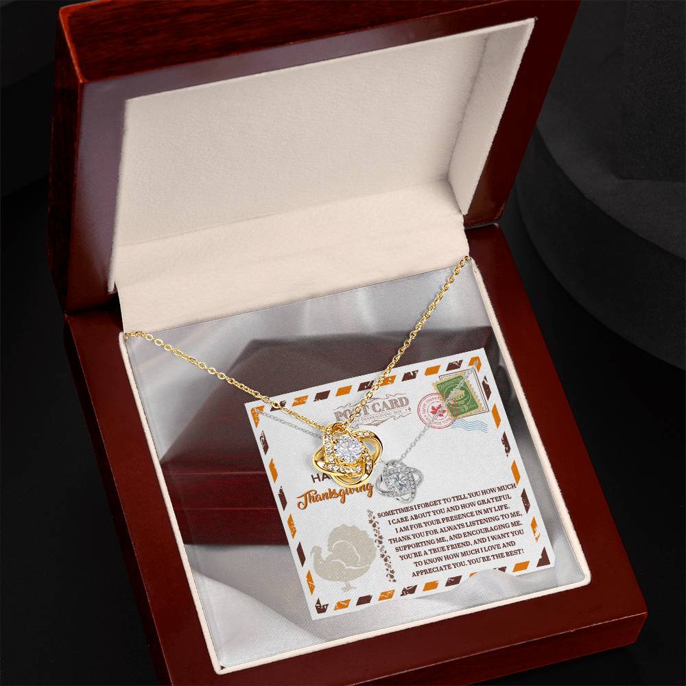 The Thanksgiving-A True Friend - Love Knot Necklace, embellished with cubic zirconia crystals, is beautifully presented in an open wooden box with a heartfelt message card. This customized gold and silver gift makes for a remarkable and meaningful gesture.