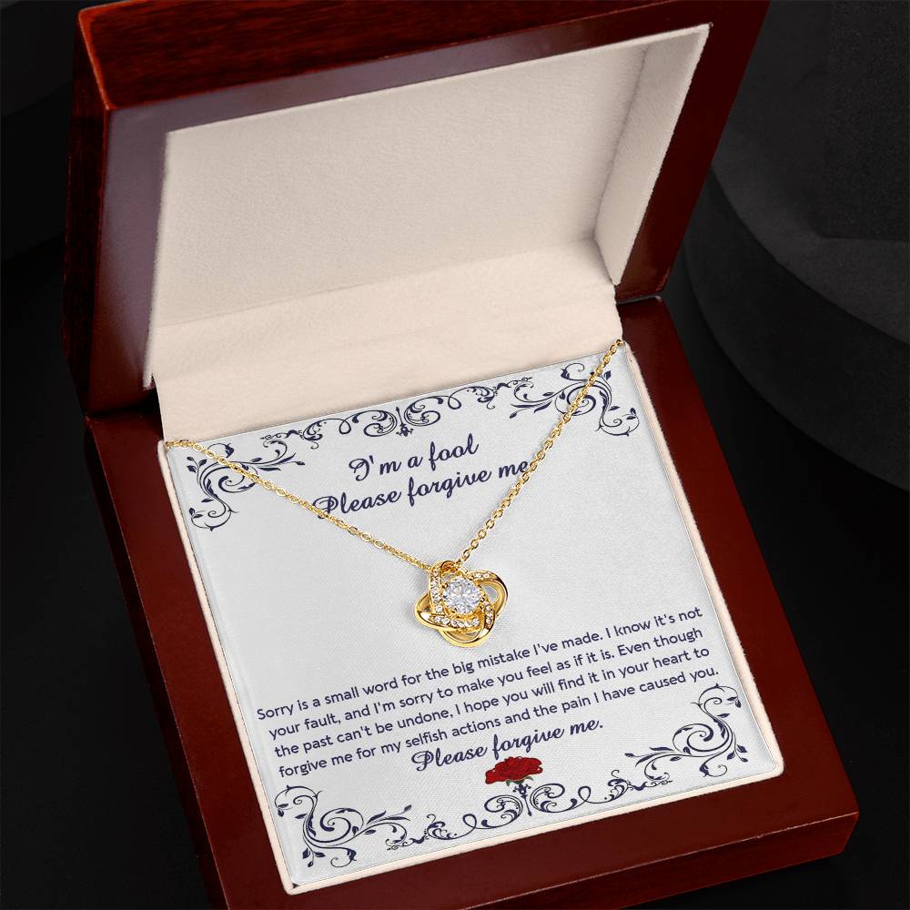 The "Sorry, I_m A Fool - Love Knot Necklace" features a 14k white gold pendant encased in a box with a heartfelt apology message. This message conveys regret and seeks forgiveness for causing pain and acting selfishly. The pendant is adorned with premium cubic zirconia crystals, adding an extra touch of elegance.