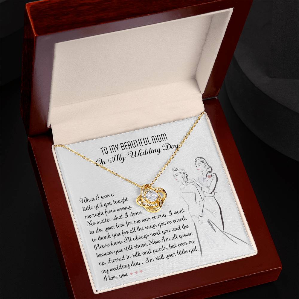 A To Mom, Wedding My Wedding Day - Love Knot Necklace with a card that reads: "To my beautiful mom on my wedding day" with a sentimental message about a daughter's gratitude towards her mother, featuring an illustration of a bride and her mother. The necklace is made of 14k white gold and adorned with cubic zirconia crystals.