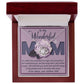 A jewelry box displaying the "To Mom, The Greatest Mom - Love Knot Necklace" adorned with cubic zirconia crystals. The card inside reads, "To my Wonderful Mom," followed by a heartfelt message from a child to their mother. This personalized gift is sure to touch her heart.