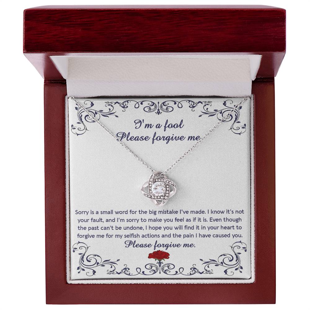 The "Sorry, I_m A Fool - Love Knot Necklace" features a 14k white gold pendant encased in a box with a heartfelt apology message. This message conveys regret and seeks forgiveness for causing pain and acting selfishly. The pendant is adorned with premium cubic zirconia crystals, adding an extra touch of elegance.