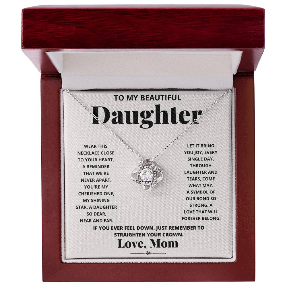 To My Beautiful Daughter, Wear This Necklace - Love Knot Necklace shaped pendant necklace with encrusted jewels on a card with a sentimental message from a mother to her daughter.