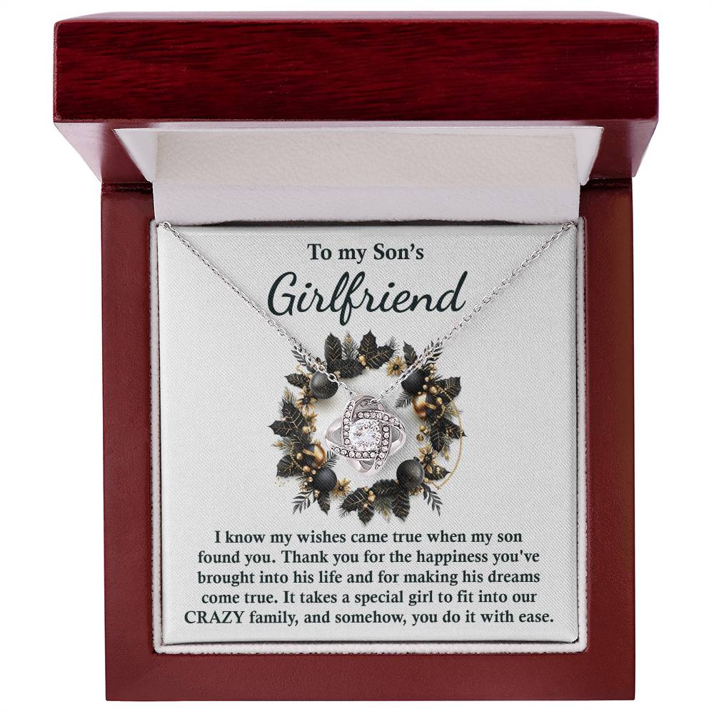 The Son's Girlfriend - Found You Love Knot Necklace features a heartfelt message in a beautiful box, expressing gratitude to a son's girlfriend for the joy she brings and warmly welcoming her into the family. This personalized gift, adorned with sparkling cubic zirconia, is the perfect way to show how much she means to you.