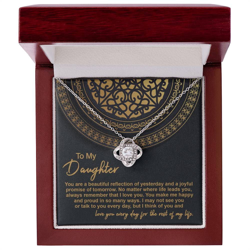 The "To Daughter, Beautiful Reflection 2 - Love Knot Necklace" in 14k white gold is elegantly presented in a black gift box adorned with gold patterns. The box carries the inscription "To My Daughter" along with a heartfelt message expressing love and pride.