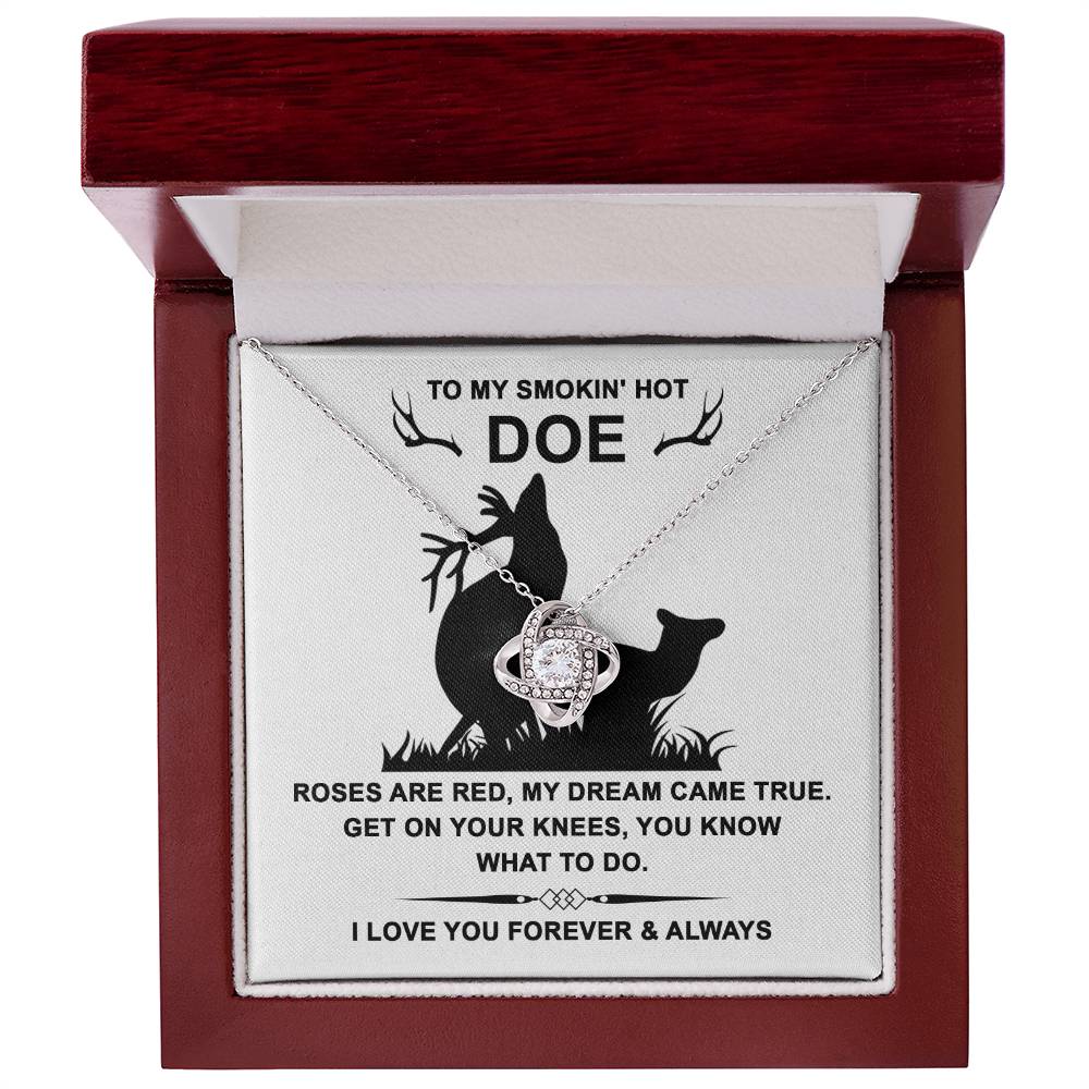 The Soulmate-Dream Came True - Love Knot Necklace has intertwined rings with cubic zirconia crystals in a box bearing the message "TO MY SMOKIN' HOT DOE..." beneath a deer silhouette, representing an unbreakable bond.