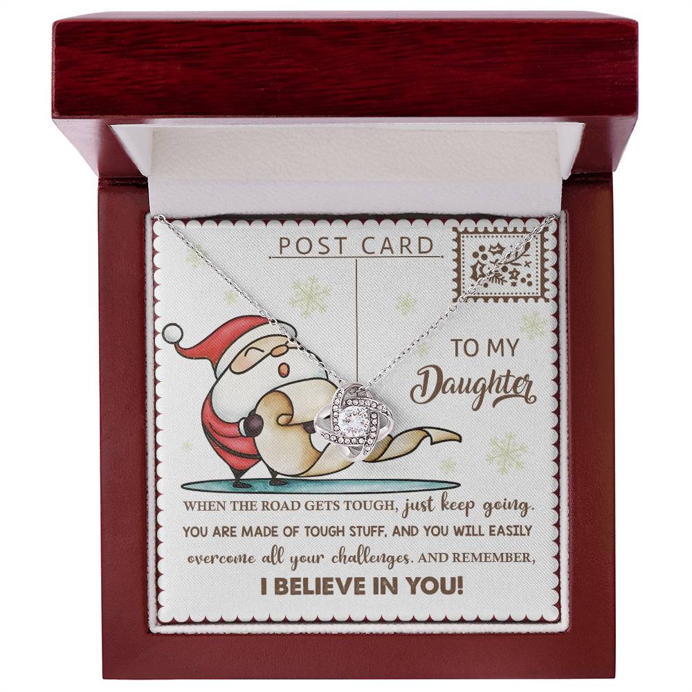 The Daughter-Keep Going - Love Knot Necklace features a circular pendant embellished with shimmering cubic zirconia, elegantly placed inside a box that displays an illustration of Santa and includes a heartfelt message to a daughter about perseverance, belief, and their unbreakable bond.