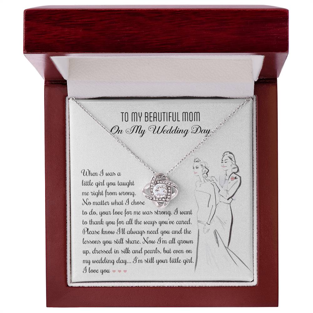 A To Mom, Wedding My Wedding Day - Love Knot Necklace with a card that reads: "To my beautiful mom on my wedding day" with a sentimental message about a daughter's gratitude towards her mother, featuring an illustration of a bride and her mother. The necklace is made of 14k white gold and adorned with cubic zirconia crystals.