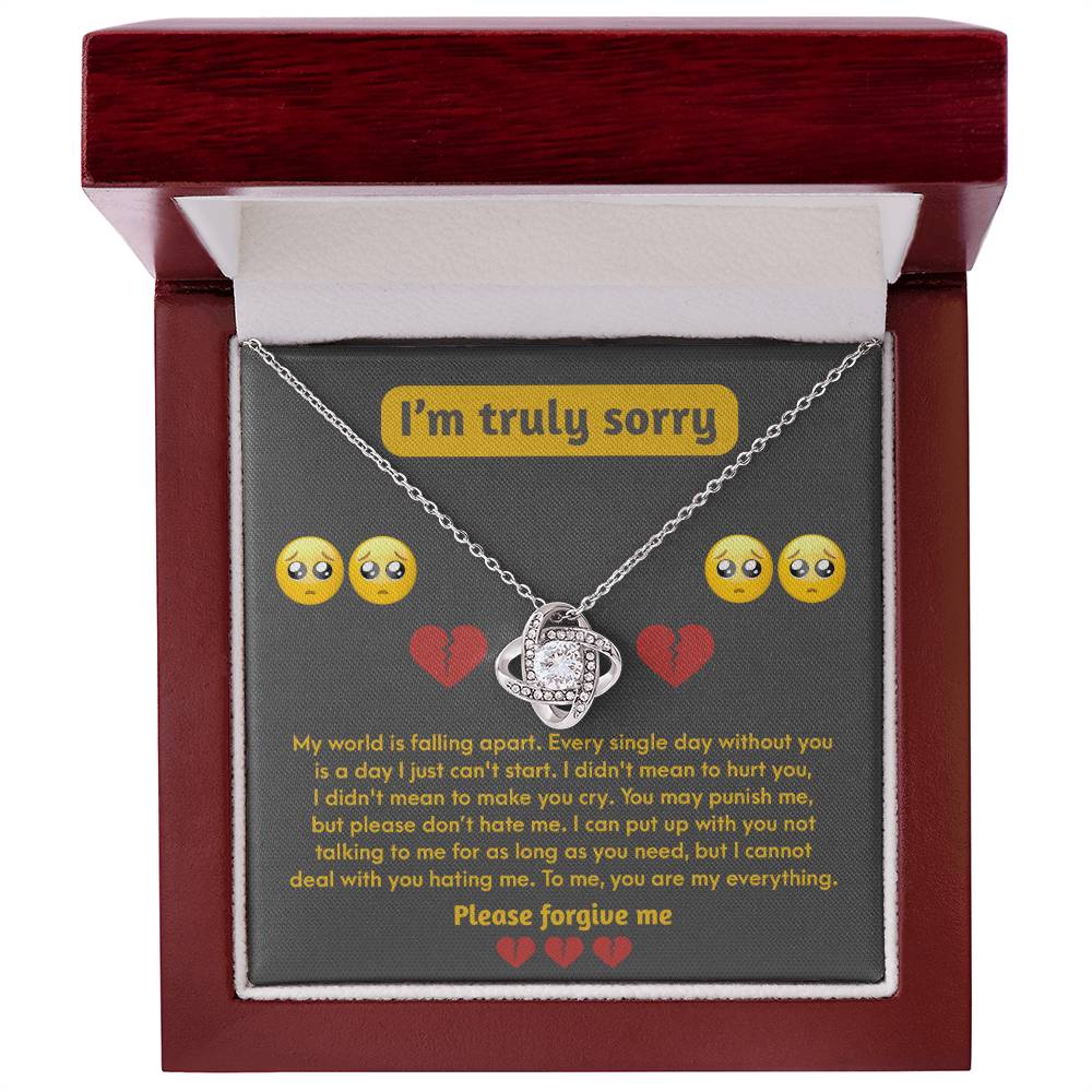 The Sorry-Make You Cry - Love Knot Necklace features a pendant adorned with cubic zirconia crystals set in 14k white gold, beautifully presented inside a jewelry box. The box lid displays an apology message, "I'm truly sorry," along with emoticons and a heartfelt request for forgiveness.