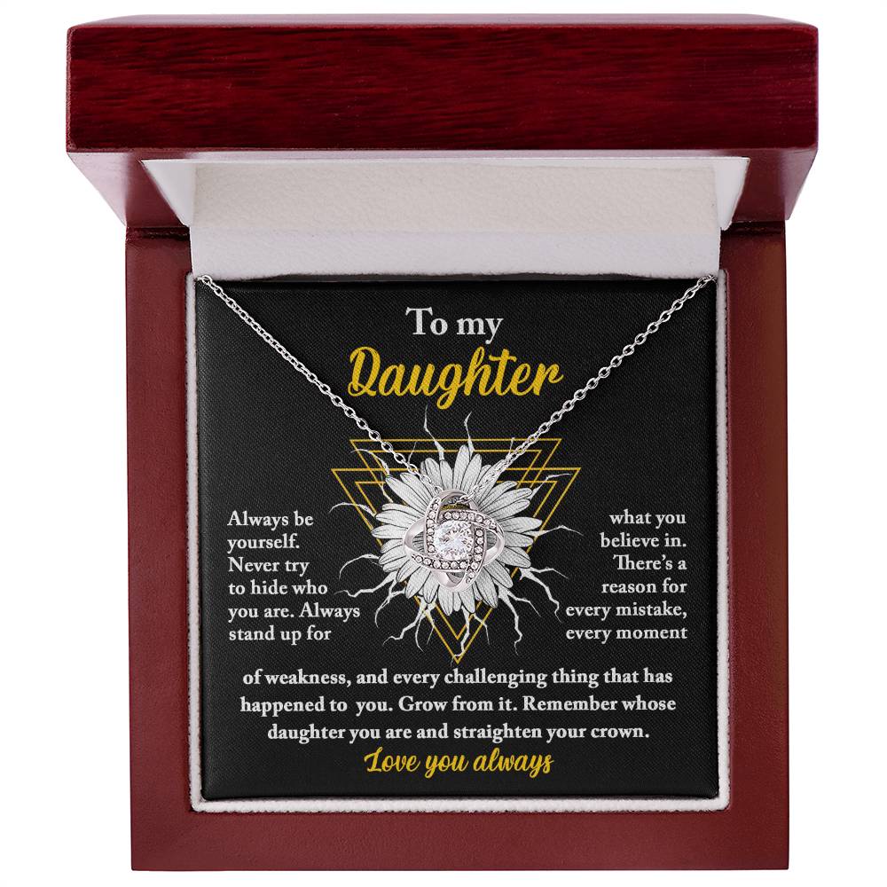 A personalized gift, this "To Daughter, Be Yourself - Love Knot Necklace" features a pendant encrusted with cubic zirconia crystals, nestled in a gift box. The box lid displays a heartfelt message addressed to "My Daughter," showcasing motivational and supportive text alongside a sunflower graphic.