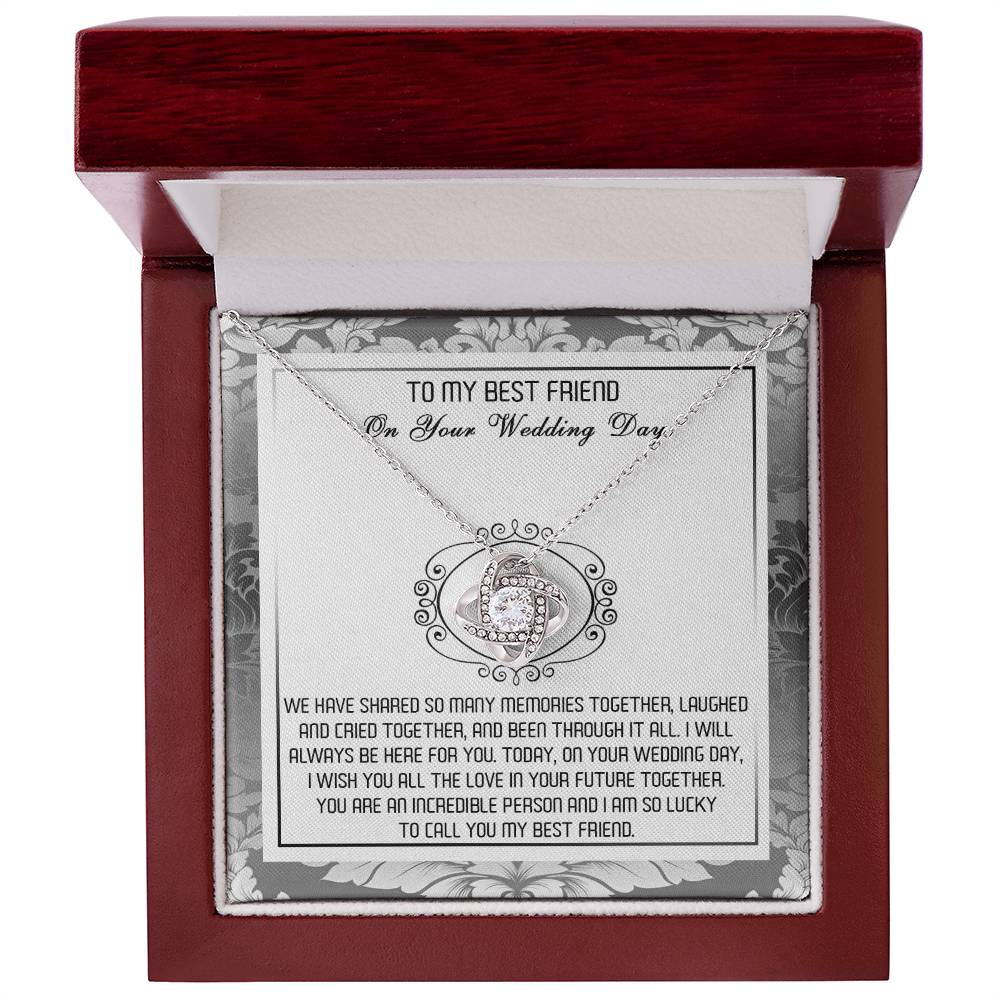 A decorative box containing the "To Best Friend, An Incredible Person - Love Knot Necklace," crafted in 14k white gold with an intricate pendant adorned with cubic zirconia crystals and a heartfelt message titled "To My Best Friend On Your Wedding Day.