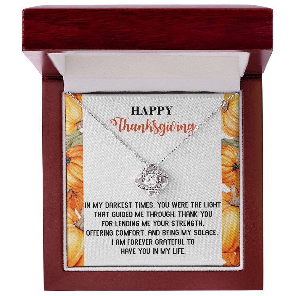 A Thanksgiving-Guided Me Through - Love Knot Necklace comes in a gift box with a decorative pumpkin design, adorned with cubic zirconia crystals and includes a heartfelt note about gratitude and support.