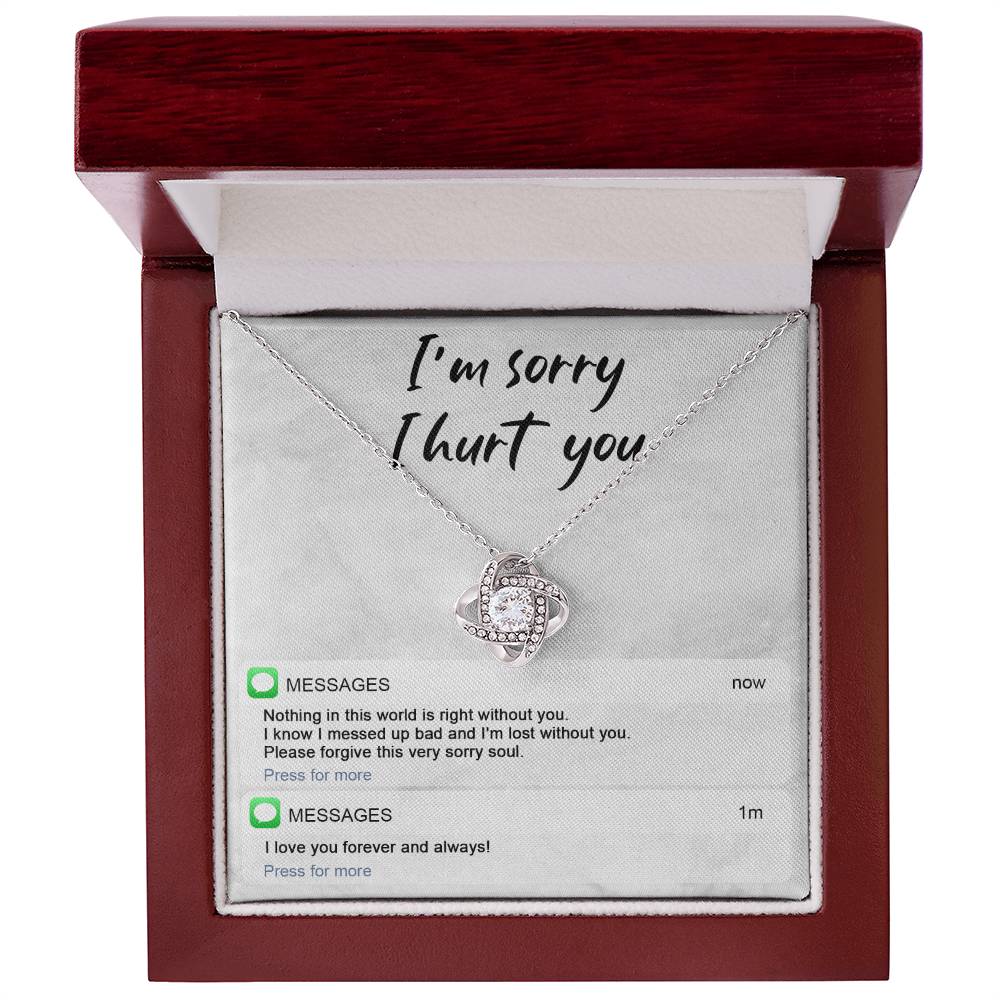 Image of the Sorry-Lost Without You - Love Knot Necklace with a diamond pendant against a background with the text "I'm sorry I hurt you." Below are text messages reading "Nothing in this world is right without you... Please forgive this very sorry soul." and "I love you forever and always!