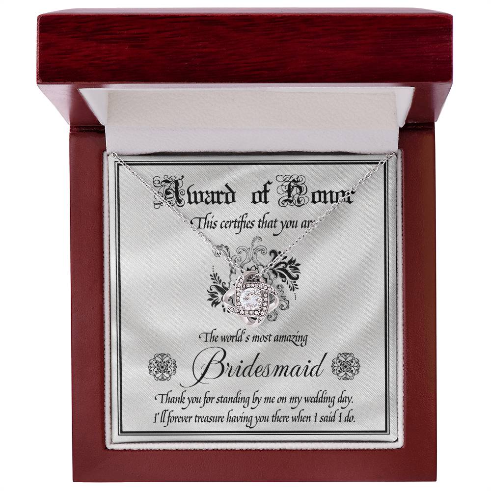 Introducing the "To Bridesmaid, Award Of Honor - Love Knot Necklace," a decorative certificate thanking the world's most amazing bridesmaid for her support on the wedding day. Featuring a Love Knot Necklace adorned with cubic zirconia crystals, this personalized gift is a heartfelt token of appreciation and love.