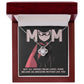 The Mom-An Awesome Mother - Love Knot Necklace, featuring a silver circular pendant, is displayed in an open jewelry box against a backdrop of a "MOM" cape illustration, with the text: "Not all heroes wear capes; some become an awesome mother like you." An ideal personalized gift to honor her heroism.