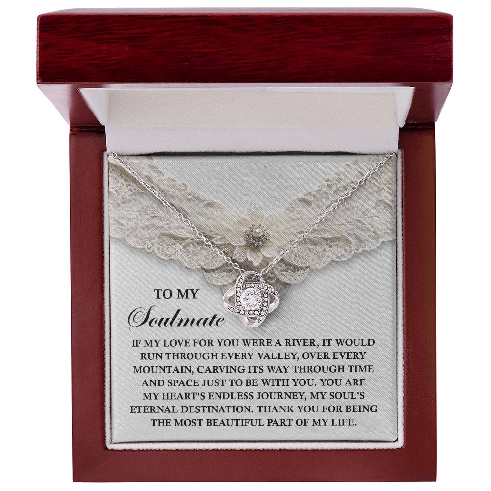 The Soulmate-Eternal Destination Love Knot Necklace, crafted with cubic zirconia, comes in a jewelry box and features a heartfelt message for your soulmate. This personalized silver necklace symbolizes deep and enduring love with its elegant heart pendant.