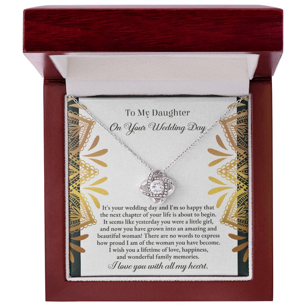 The "To Daughter, Wedding - A Little Girl - Love Knot Necklace" adorned with cubic zirconia crystals is elegantly showcased in a box containing a heartfelt message for a daughter on her wedding day. The text conveys love, pride, and best wishes for a joyful marriage, beautifully accentuated by the option of a white gold or yellow gold finish.