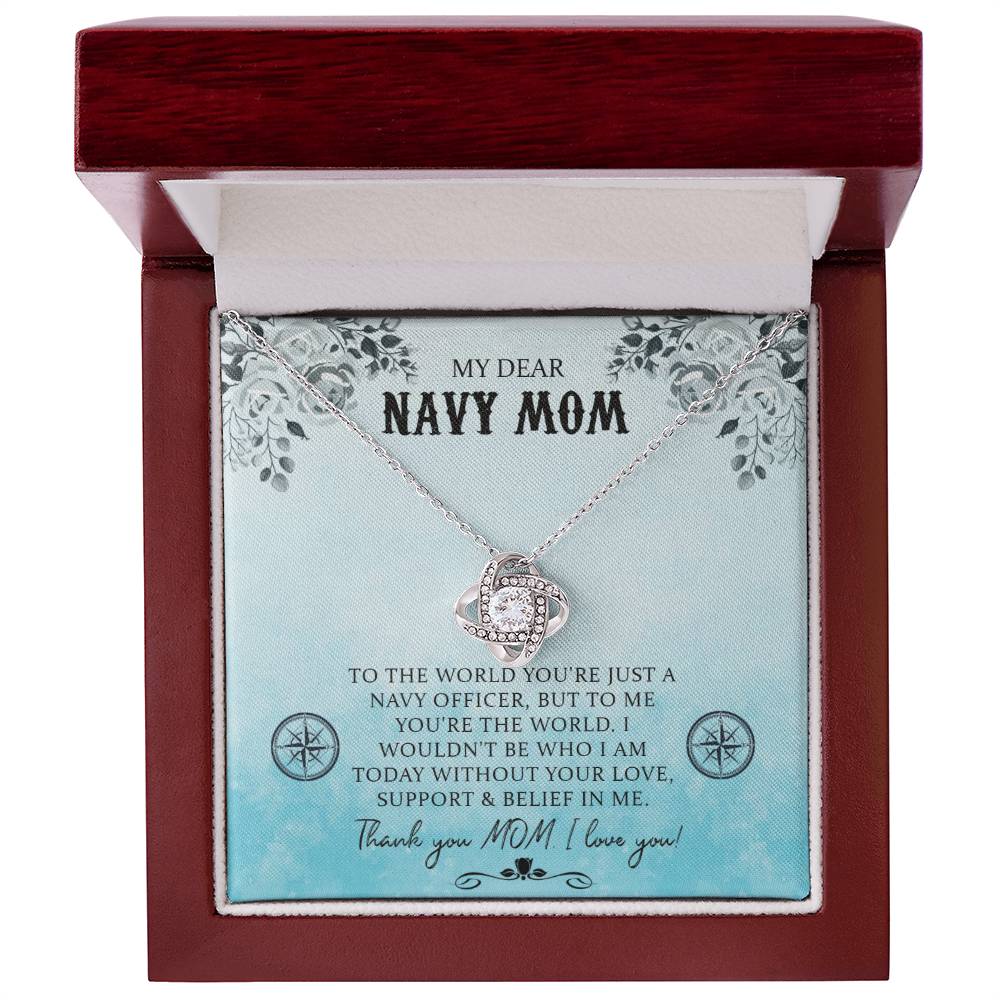 A My Dear Navy Mom, To The World You're Just A Navy Officer - Love Knot Necklace with a pendant, adorned with cubic zirconia crystals, is presented inside a gift box with an inscription dedicated to a "navy mom," expressing gratitude and love by ShineOn Fulfillment.