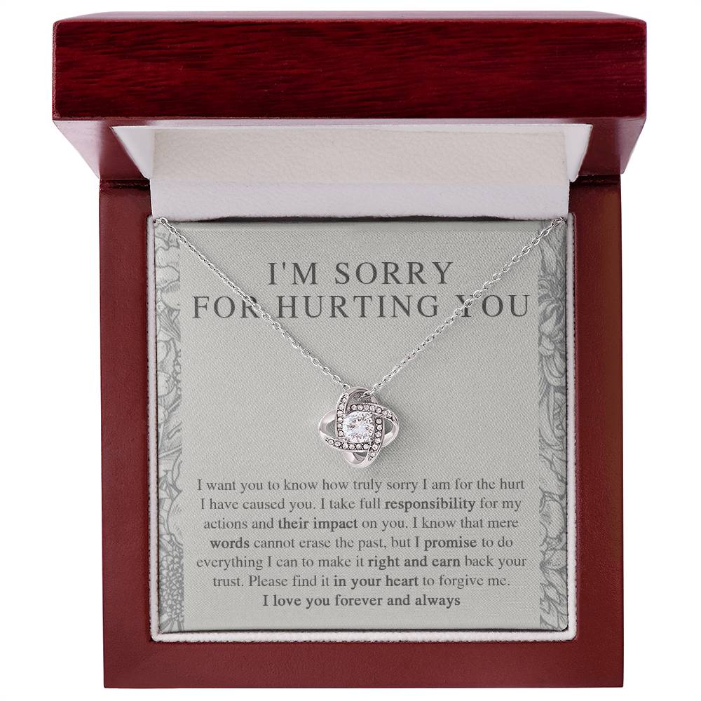 The Sorry-Do Everything - Love Knot Necklace features an eye-catching silver intertwined pendant, elegantly adorned with cubic zirconia crystals, showcased against a heartfelt printed apology message. The message conveys sincere regret, taking responsibility, and earnestly asking for forgiveness with love.