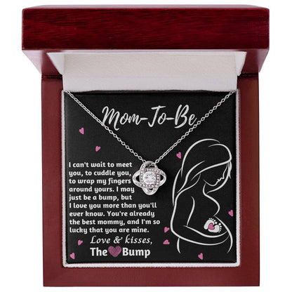 A To Mama To Be, The Best Mommy - Love Knot Necklace with a pendant inscribed "mom-to-be" in a gift box with a heartfelt message for an expectant mother from ShineOn Fulfillment.