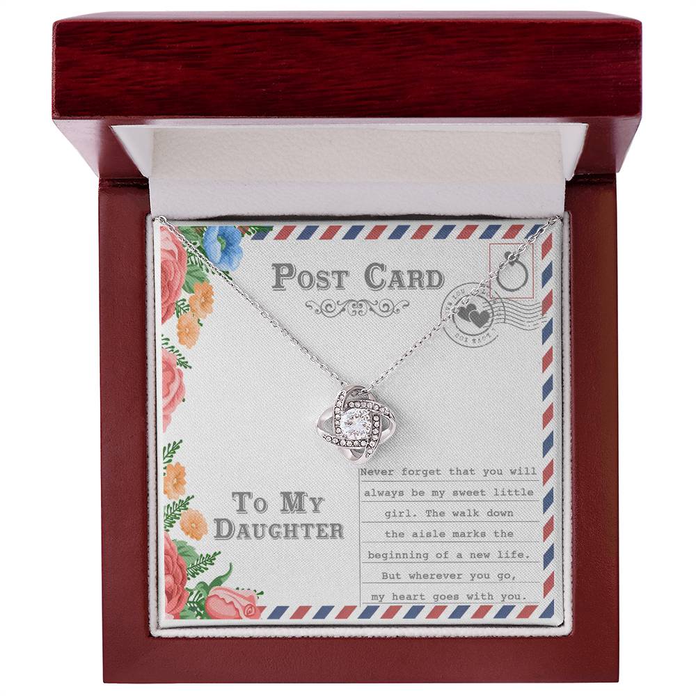 The "To Daughter, Goes With You - Love Knot Necklace," featuring an intertwining design with a gold finish and adorned with cubic zirconia crystals, is displayed on a postcard that reads "To My Daughter." The message includes a heartfelt note about your daughter's wedding and a mother's enduring love.