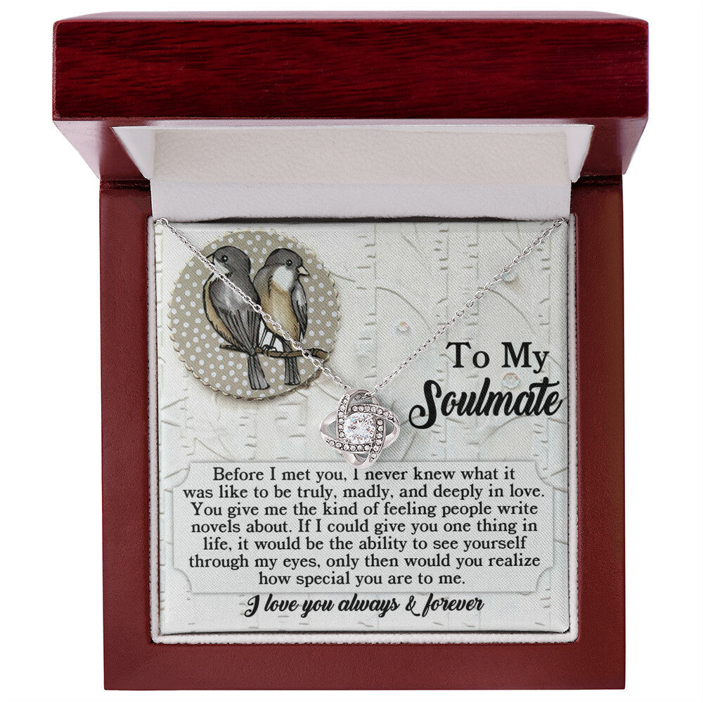 The Soulmate-Write Novels - Love Knot Necklace, embellished with Cubic Zirconia Crystals, symbolizes everlasting connections. Presented in a red and white box featuring a "To My Soulmate" message and two birds, it makes an ideal gift.