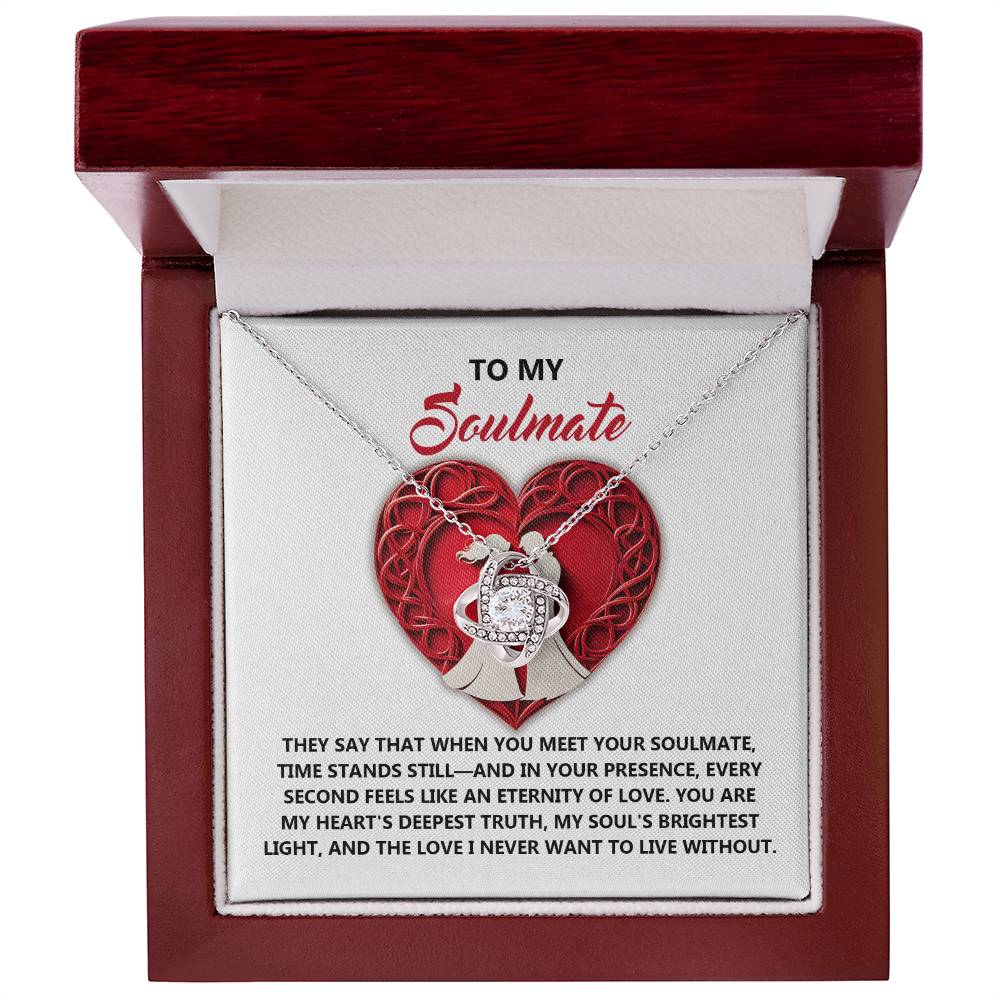 The Soulmate-Deepest Truth Love Knot Necklace features a heart-shaped pendant in an open red and white box with the message: "To my Soulmate," along with a sentimental paragraph about love, adorned with sparkling cubic zirconia crystals, ideal as a personalized gift.