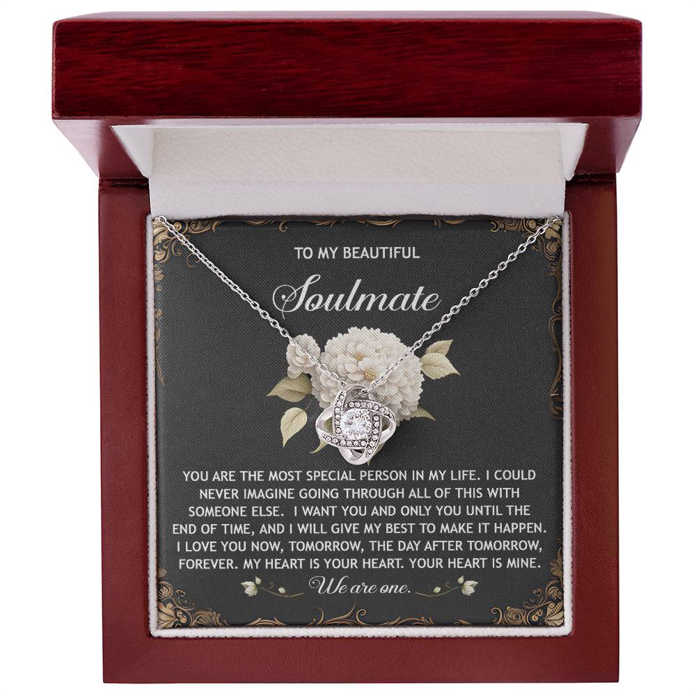 The Soulmate-We Are One Love Knot Necklace is beautifully showcased in a red box with sparkling cubic zirconia crystals, featuring a heartfelt message for a soulmate that expresses deep love and commitment—a personalized gift meant to be cherished forever.