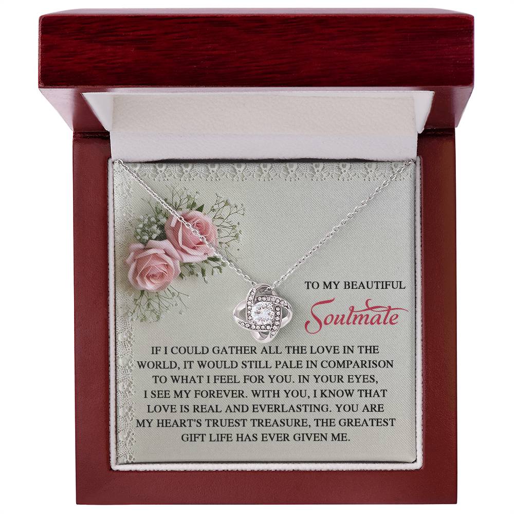 The Soulmate-Given Me - Love Knot Necklace is presented in a red box with roses and a message, "To My Beautiful Soulmate," symbolizing eternal love. Featuring cubic zirconia crystals and a white gold finish, it represents the enduring bond shared by two intertwined hearts.