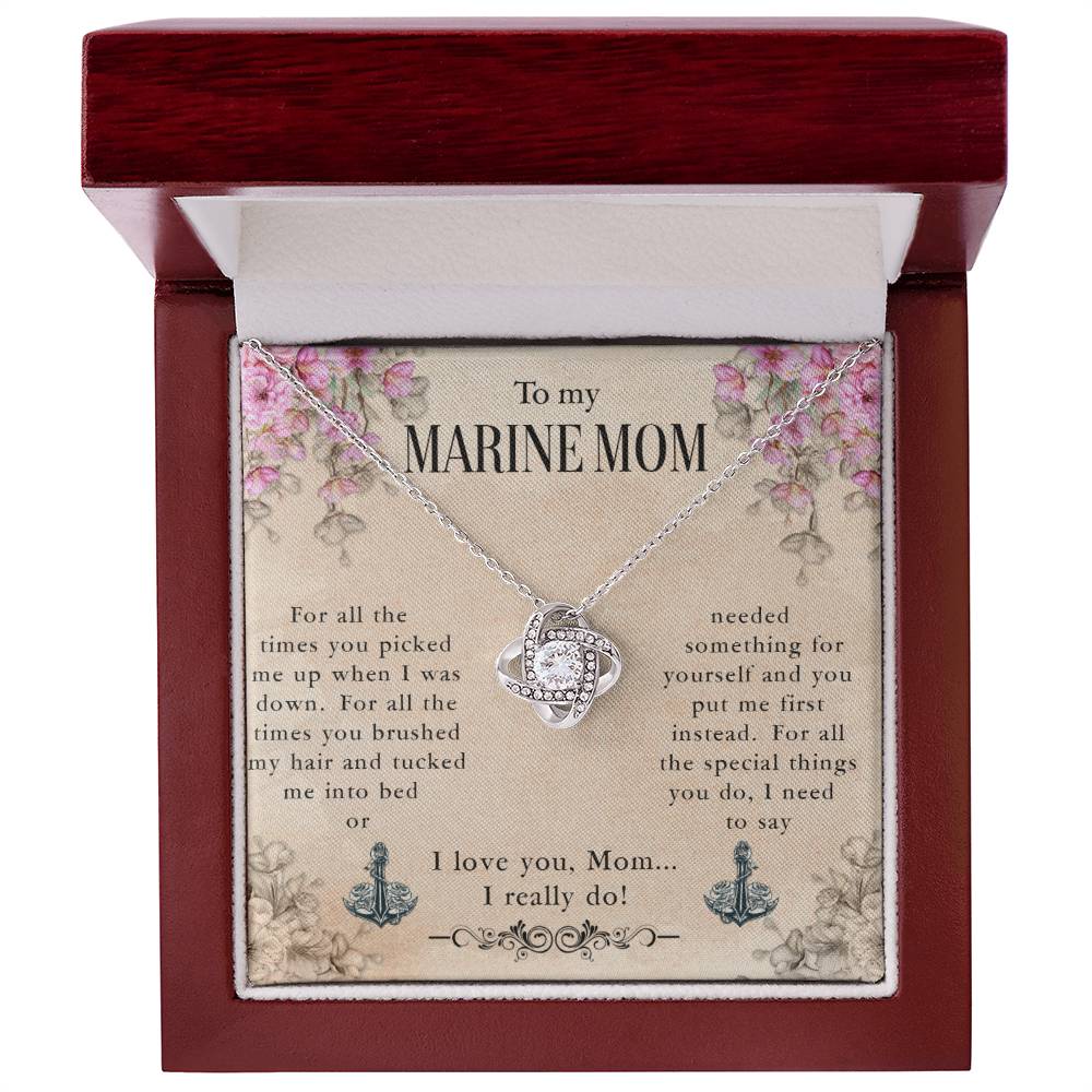 A silver To My Marine Mom, For All The Times You Picked Me Up - Love Knot Necklace with an embossed marine emblem and cubic zirconia crystals, presented in a gift box with a heartfelt message to a "marine mom" by ShineOn Fulfillment.