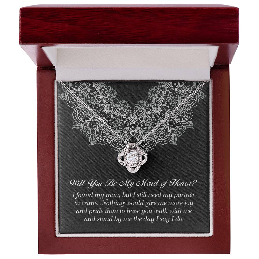 A decorative box with a "To Maid Of Honor, Partner In Crime - Love Knot Necklace" featuring a cubic zirconia; the text inside reads, "Will You Be My Maid of Honor?" followed by a heartfelt message.