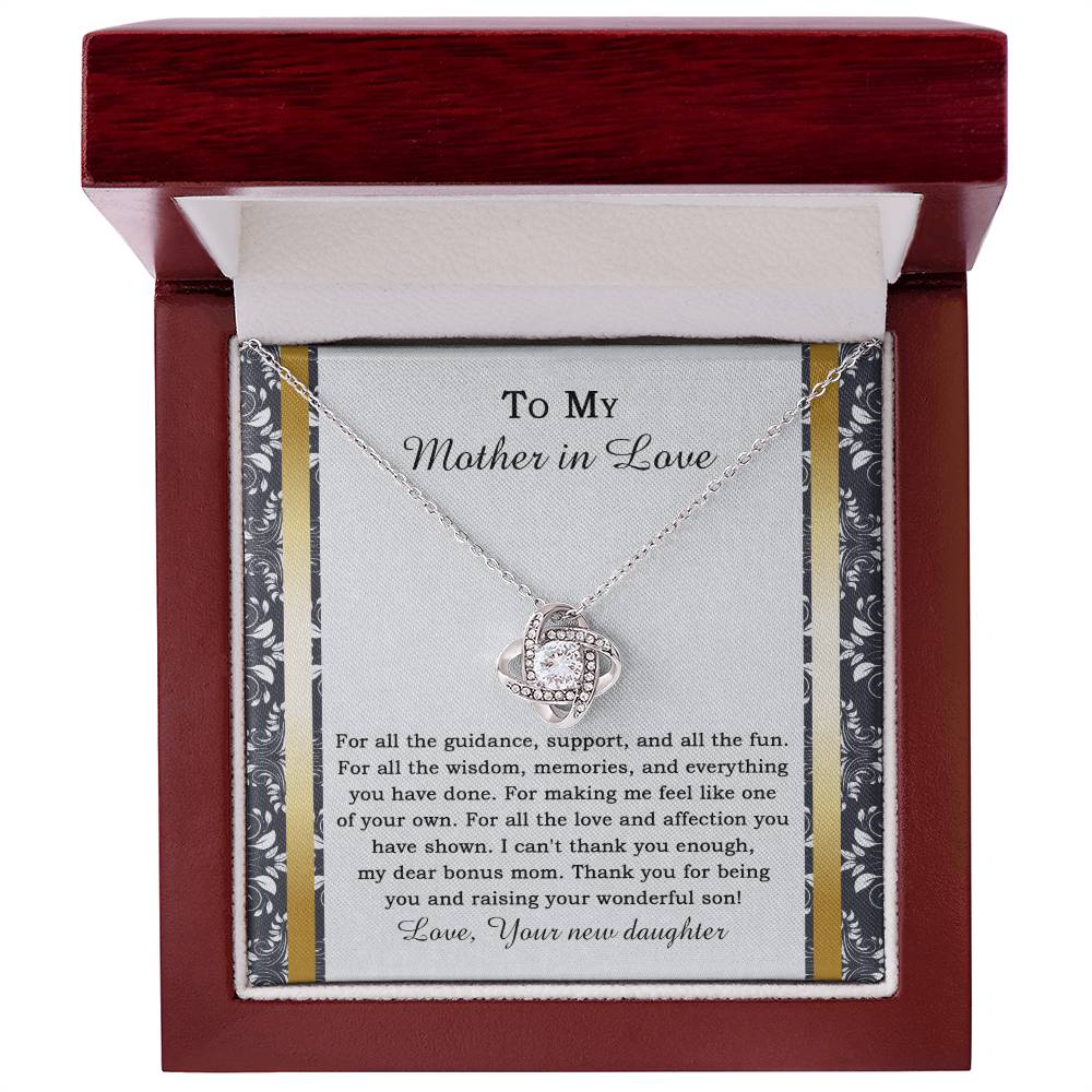 The "To Mother-in-law, Of Your Own - Love Knot Necklace" features a heart-shaped pendant adorned with cubic zirconia crystals, and it comes on a card expressing gratitude for a mother-in-law's love and support.