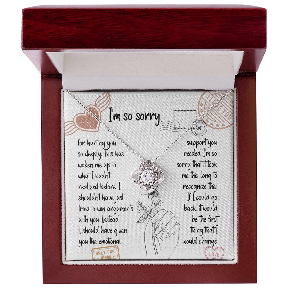 The Sorry-Emotional Support - Love Knot Necklace, featuring an intertwined knot pendant adorned with cubic zirconia crystals, is displayed on a card with an apology message expressing regrets and promising better emotional support in the future.