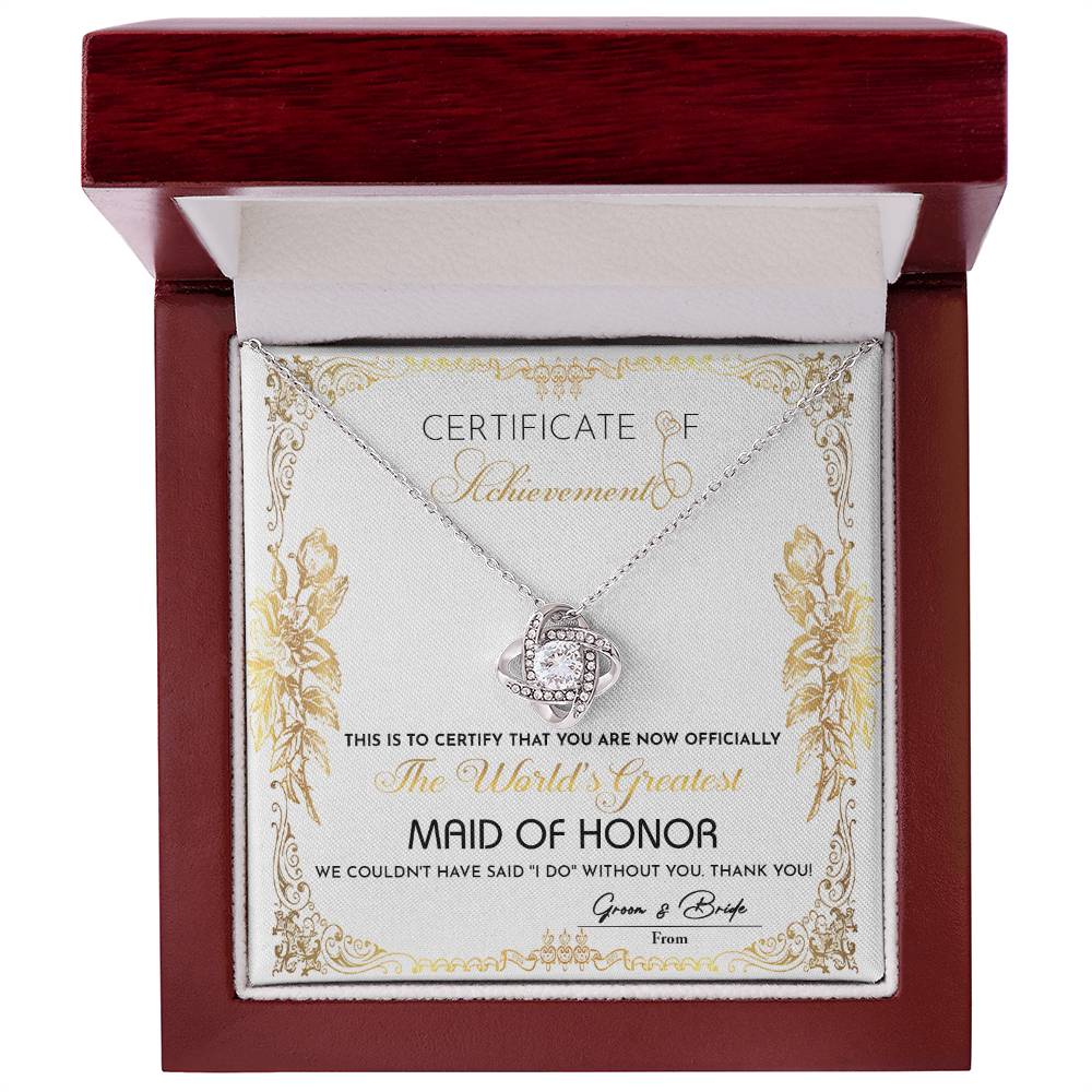 Presenting the "To Maid Of Honor, Certificate Of Achievement - Love Knot Necklace," designed to honor the world's greatest maid of honor. This exquisite necklace, offered in a choice of white gold or yellow gold finish and adorned with shimmering cubic zirconia, represents the heartfelt gratitude of the bride and groom for their invaluable role in the wedding.