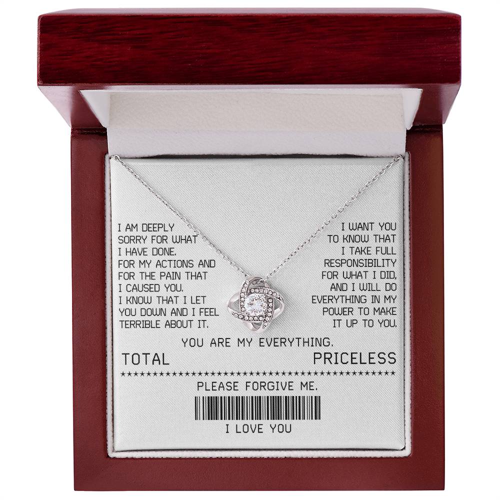 The Sorry-Make It Up - Love Knot Necklace, featuring a white gold finish and adorned with shimmering cubic zirconia crystals, is beautifully presented on a card with an apology message. This card includes phrases such as "TOTAL PRICELESS," "PLEASE FORGIVE ME," and "I LOVE YOU," along with a barcode, making it the perfect elegant touch for your sincere apology.