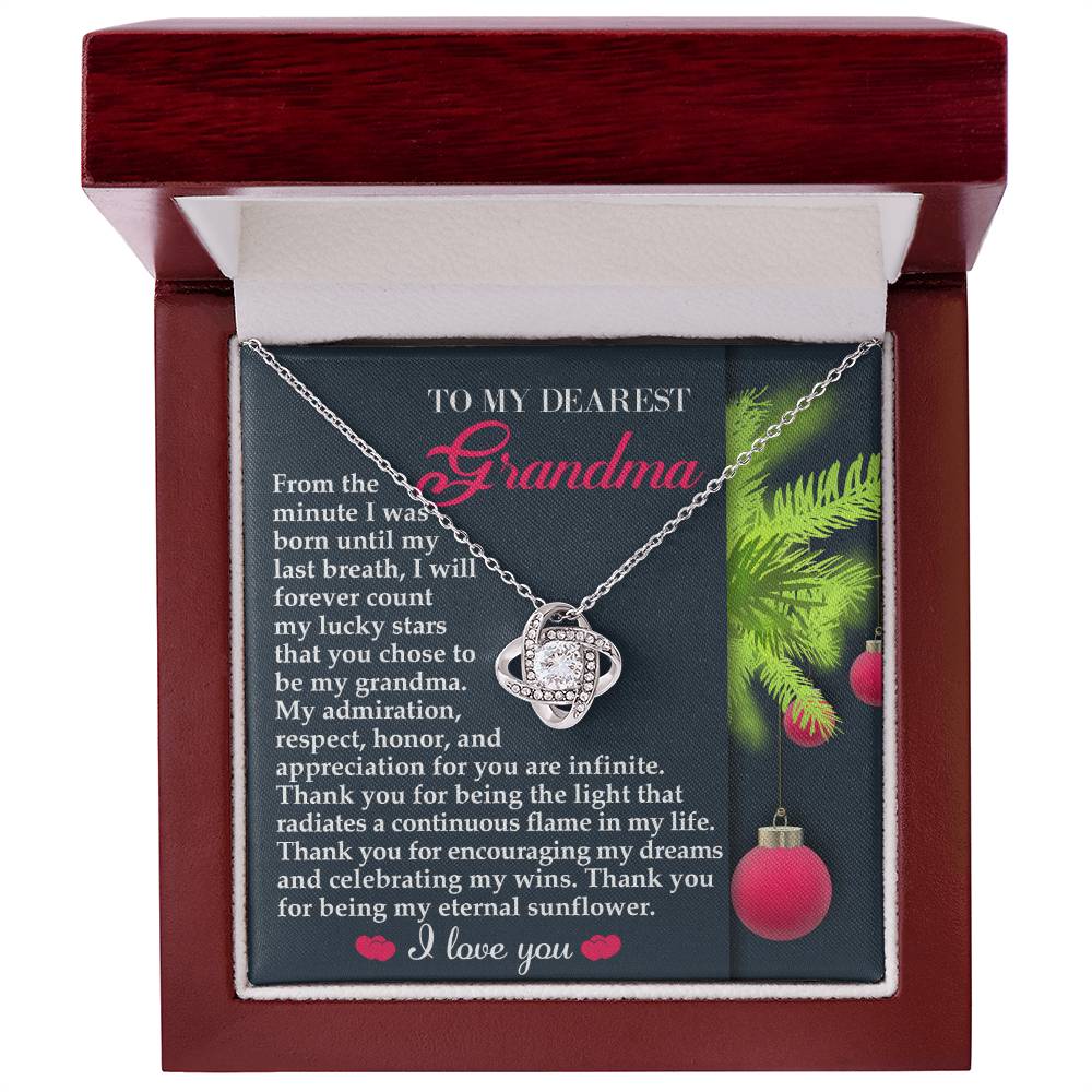 The Grandma-Eternal Sunflower - Love Knot Necklace, featuring a dazzling cubic zirconia centerpiece, is beautifully presented in a gift box. With an accompanying heartfelt note for "Grandma," it conveys love and gratitude, its radiant white gold finish mirroring the depth of the sentiment.