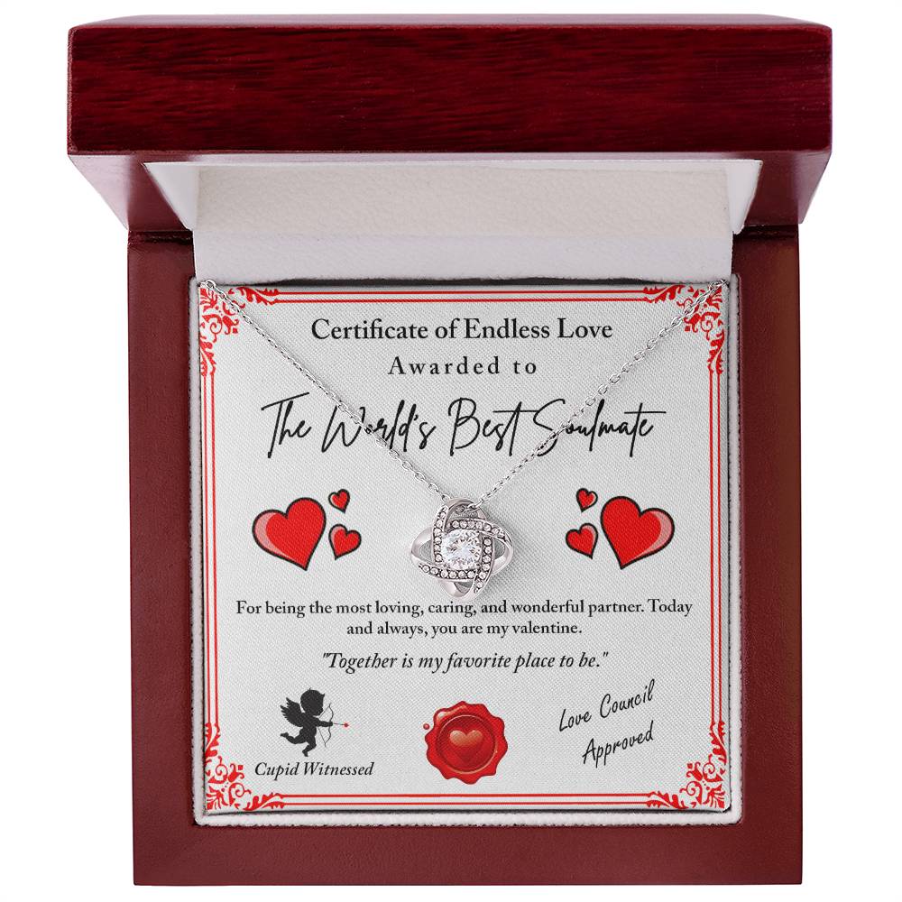 The Love Certificate-Cupid Witnessed - Love Knot Necklace features a heart-shaped pendant adorned with cubic zirconia crystals in a wooden gift box and includes a decorative certificate with romantic text and red hearts.