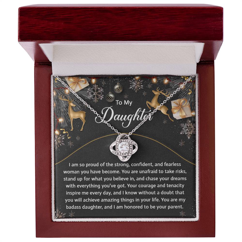 A Daughter-Amazing Things - Love Knot Necklace, elegantly presented in a jewelry box adorned with shimmering cubic zirconia crystals and a heartfelt message card that reads, "To My Daughter," along with motivational words and holiday-themed decorations, makes for the perfect personalized gift.