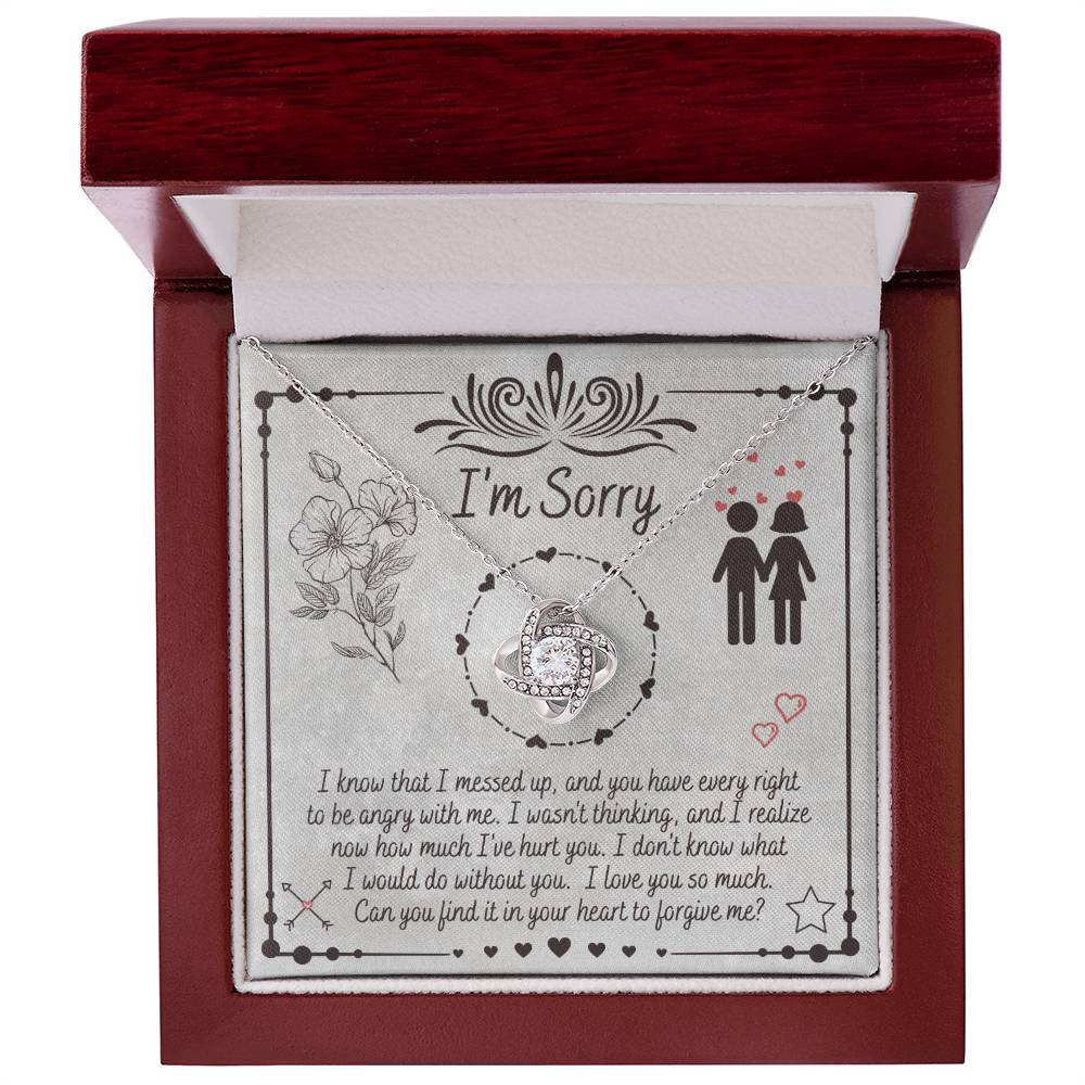 The "Sorry-I Would Do - Love Knot Necklace" is a personalized gift box that includes an apology message and a Love Knot Necklace adorned with cubic zirconia crystals. The box features the phrase "I'm Sorry" above illustrations of flowers and a couple, expressing regret for a mistake and seeking forgiveness.