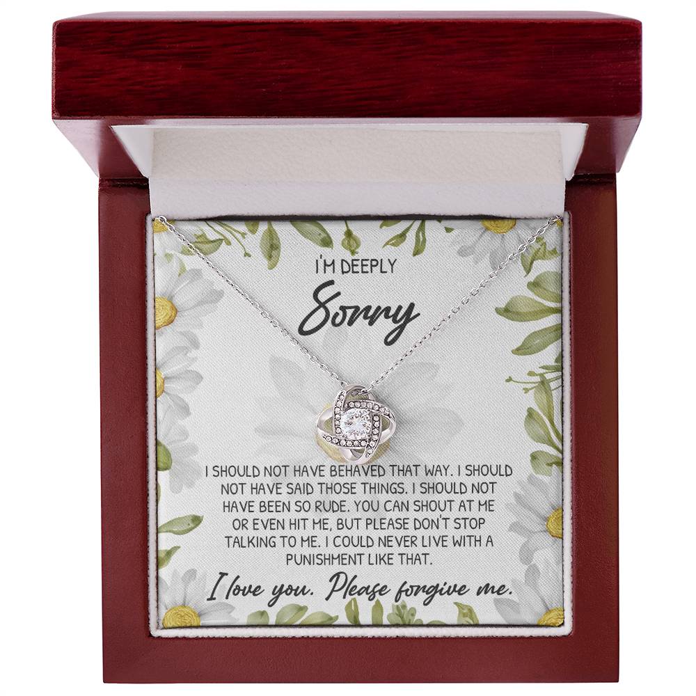 The Sorry-Please Don't Top - Love Knot Necklace, embellished with cubic zirconia crystals, rests in a red box and is accompanied by a heartfelt apology message printed on a floral background.