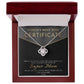 The Mom-Best Mom Certificate - Love Knot Necklace with a circular cubic zirconia pendant and gold finish is showcased in an open wooden box. A certificate behind it reads "World's Best Mom" and "Super Mom" in gold letters, while the necklace rests elegantly on a white interior.