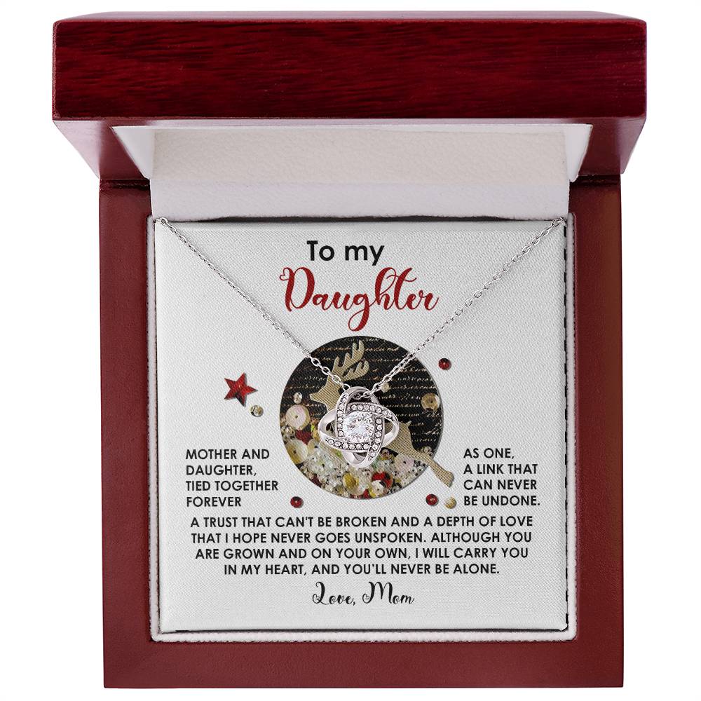 The Daughter-Forever As One - Love Knot Necklace, nestled in a box adorned with cubic zirconia crystals, carries a heartfelt message from a mother to her daughter, celebrating their unbreakable bond and love. This unique gift symbolizes the endless connection shared between them.