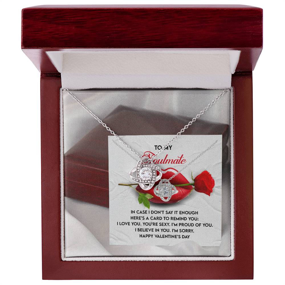 The Soulmate-Don’t Say It - Love Knot Necklace features intertwined rings in a red box. Inside the lid, find a rose graphic with Valentine's Day wishes and love expressions. Perfect for a loved one, it adds elegance with dazzling cubic zirconia accents.