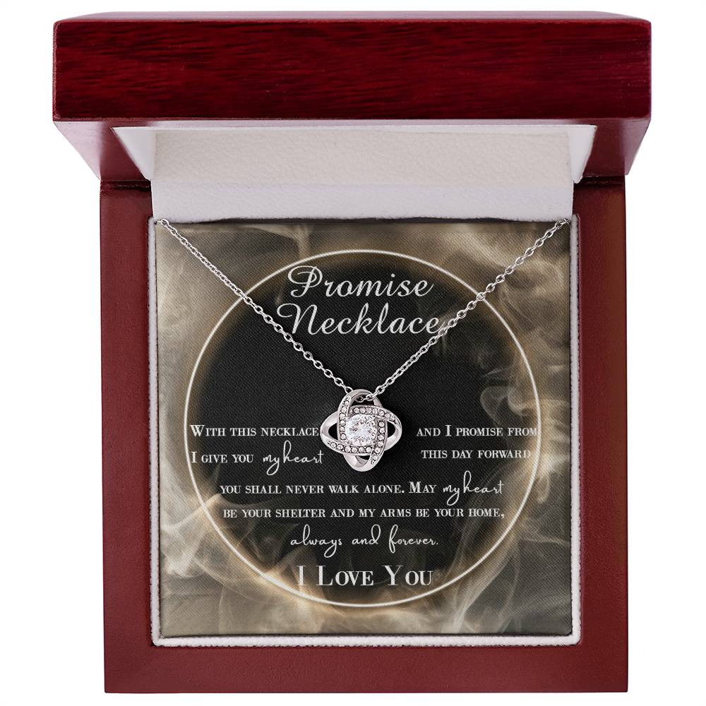 A To Wife, Promise Necklace - Love Knot Necklace with interlocking hearts, adorned with small cubic zirconia crystals and a gold finish, displayed in a box with a romantic message.